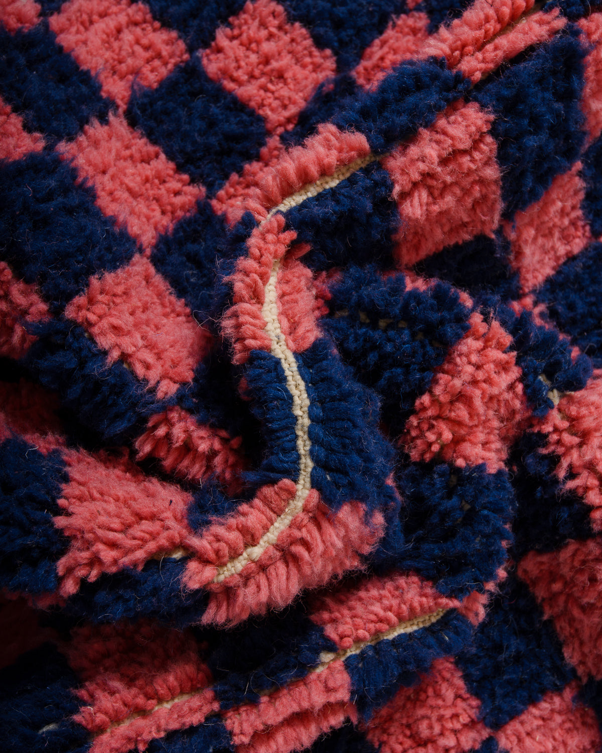 Detail of wool berber rug showing depth of pile and different coloured wool used.